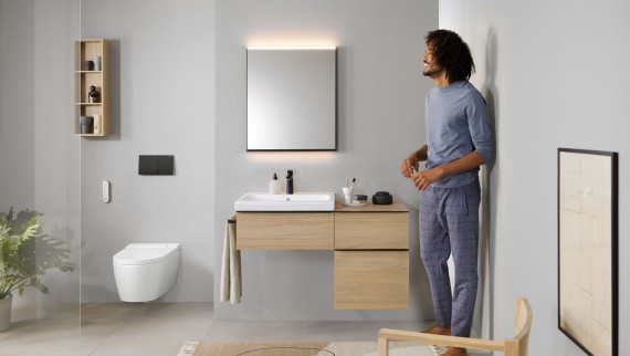 Man in a bathroom with Geberit AquaClean Sela