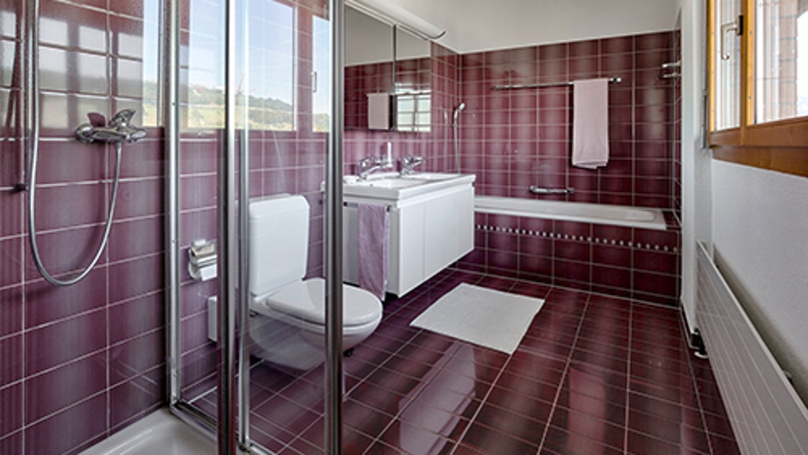 Bathroom before renovation with red tiles Bathroom before renovation with red tiles