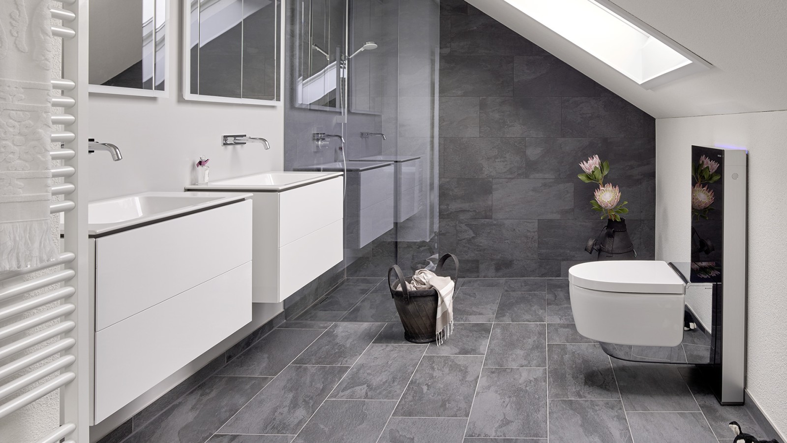 Bathroom with sloping roof and products from the Geberit ONE bathroom series and Geberit AquaClean with Monolith Bathroom with sloping roof and products from the Geberit ONE bathroom series and Geberit AquaClean with Monolith