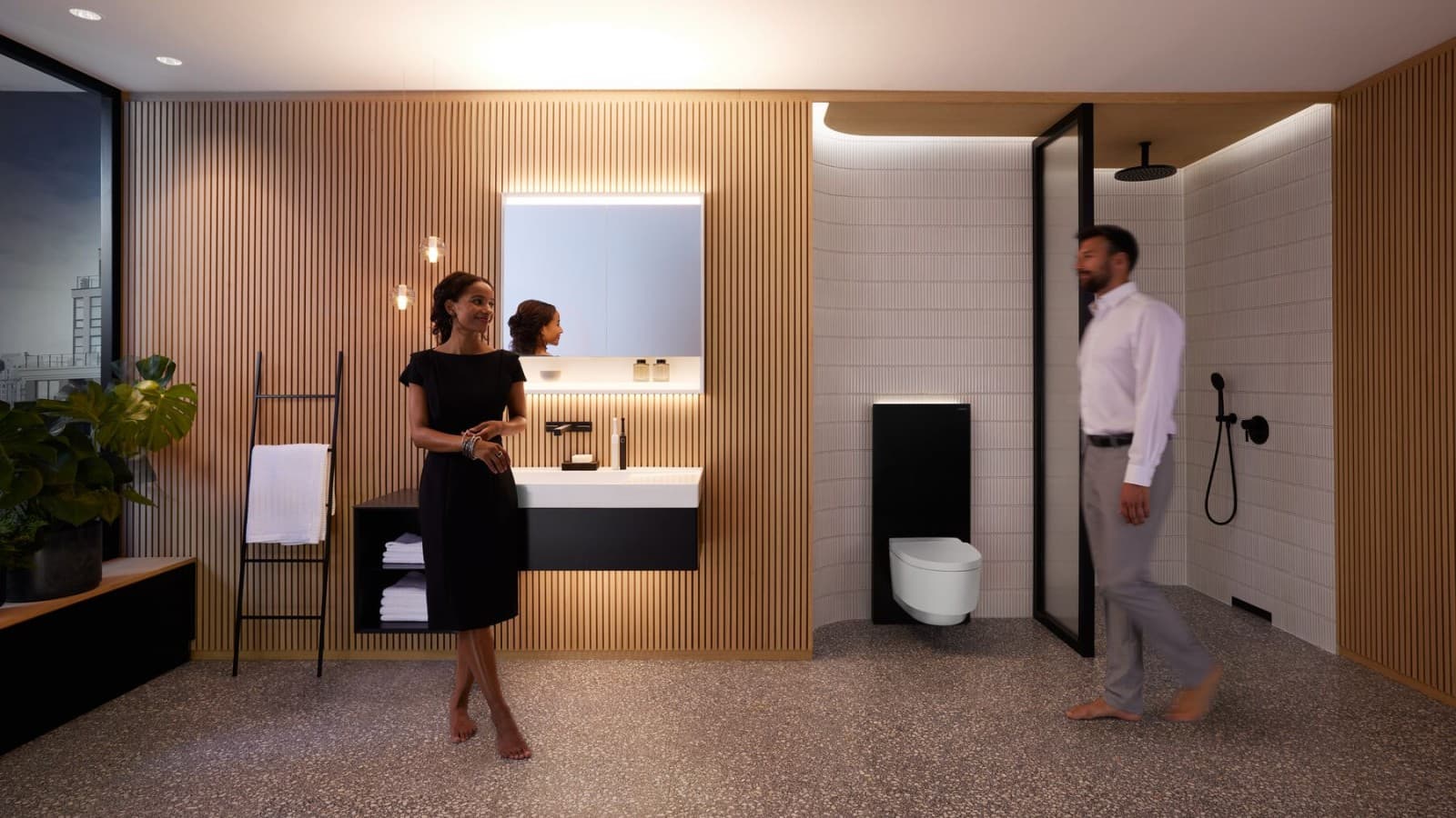 Man and woman in perfectly lit bathroom with Geberit ONE products Man and woman in perfectly lit bathroom with Geberit ONE products