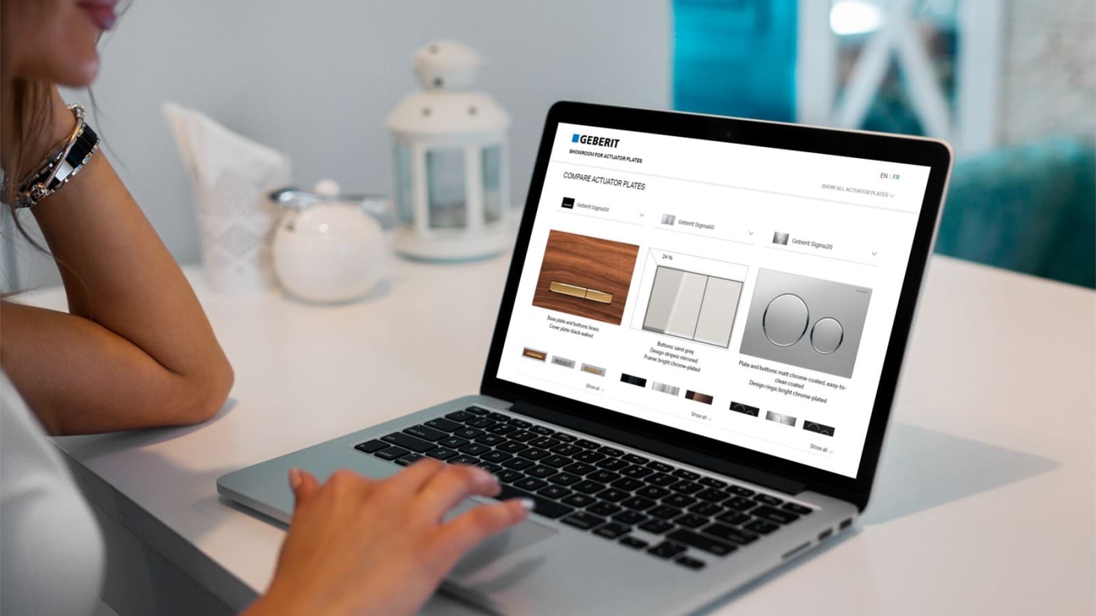 Woman compares actuator plates from Geberit Woman compares actuator plates from Geberit